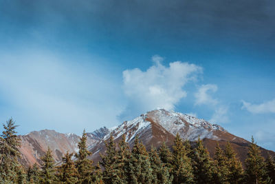 Scenic view of mountains against blue sky