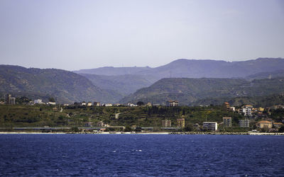 Scenic view of sea and buildings against sky