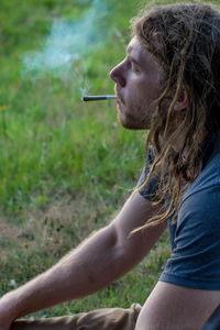 Side view of man smoking cigarette