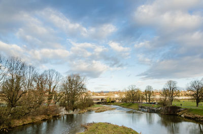 River amidst trees against sky