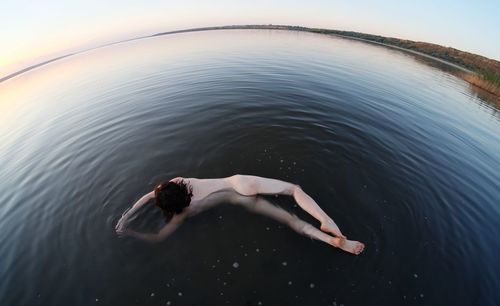 Low section of woman swimming in lake