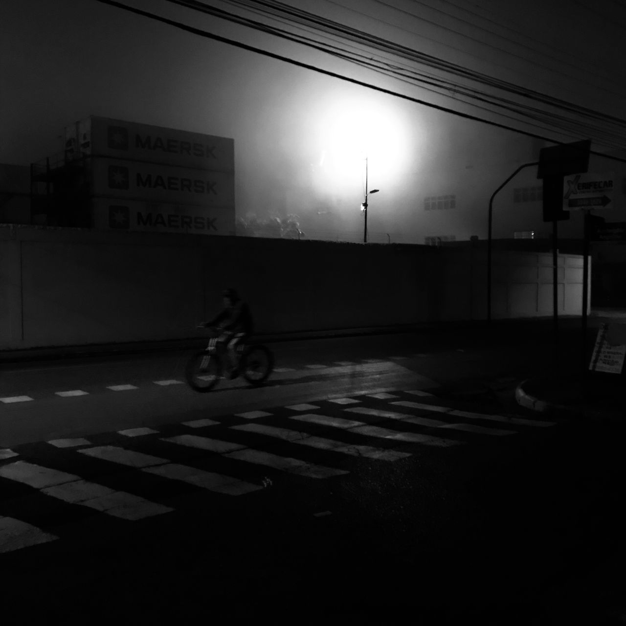 MAN RIDING BICYCLE ON ROAD IN CITY