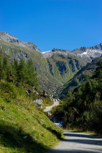 Scenic view of mountains against clear blue sky