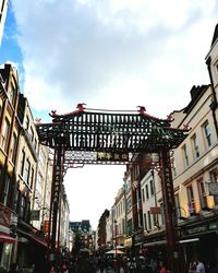 Low angle view of buildings against cloudy sky