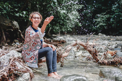 Portrait of young woman standing in lake
