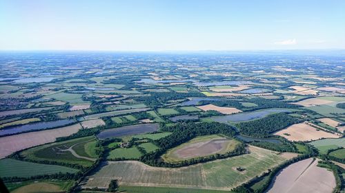 Aerial view of agricultural field against sky