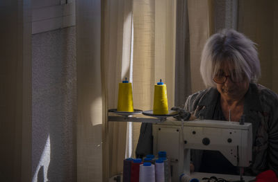 Portrait of mature woman working in her trailer workshop