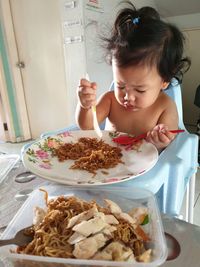 Cute girl sitting on table