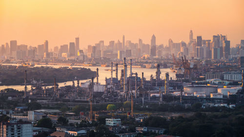 High angle view of buildings in city during sunset