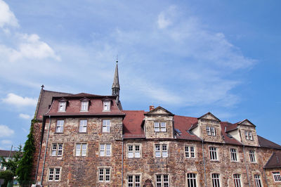 Low angle view of building against cloudy sky