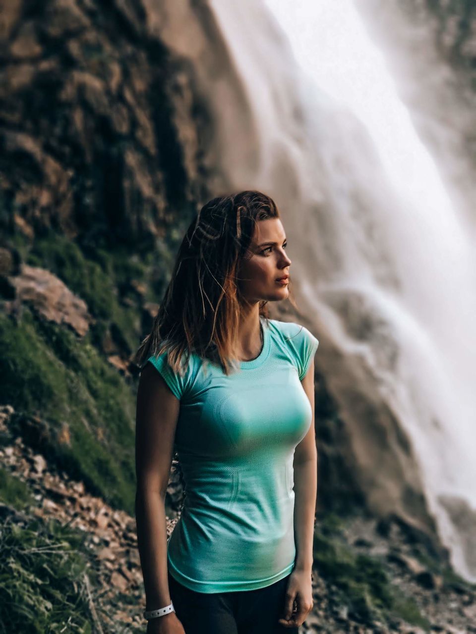 YOUNG WOMAN STANDING AGAINST SUN