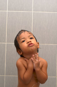 Cute shirtless girl bathing in bathroom