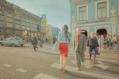 People walking on road in city