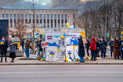 Protesters holding signs and flags participated at a - stand with ukraine.