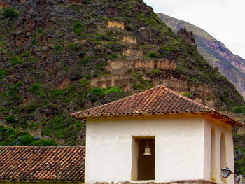 House on mountain against sky