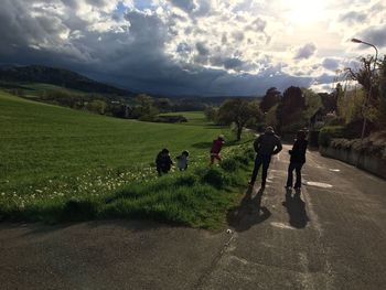 People walking on road against sky