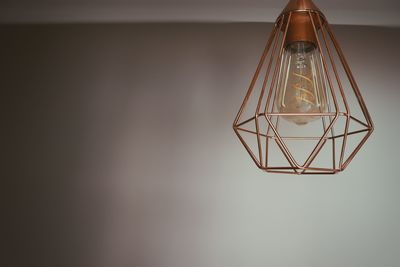 Low angle view of illuminated light bulbs hanging from ceiling