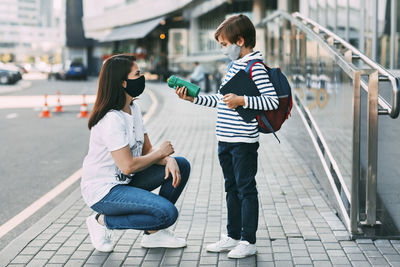 Close-up of mother and son on street