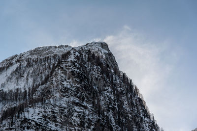 Low angle view of snowcapped mountain against sky