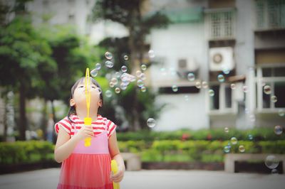 Girl playing with bubble wand