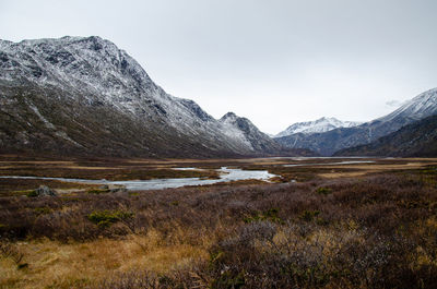 Scenic view of a river weaving through norway's highlands and snowcapped mountains