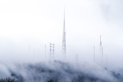 Low angle view of communications tower against sky