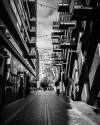 Street amidst buildings in city against sky