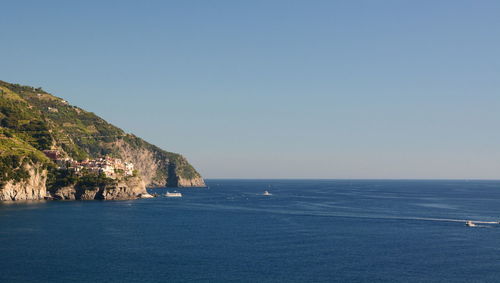 Scenic view of sea against clear blue sky