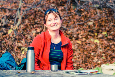 Portrait of woman smiling while sitting at table