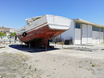 Abandoned building against clear blue sky