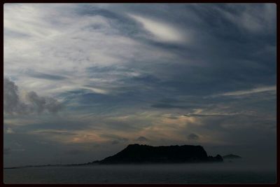 Scenic view of sea against cloudy sky