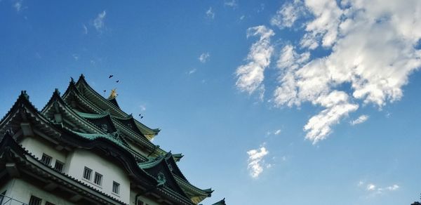 Low angle view of buildings against blue sky