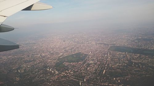 Aerial view of airplane wing against sky