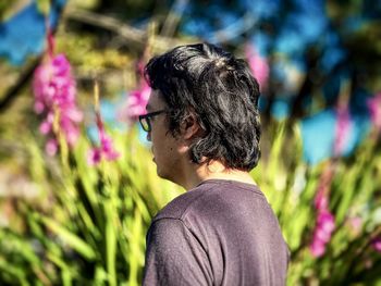 Rear view of woman with pink flower