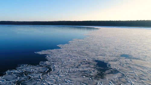 Scenic view of frozen lake against sky