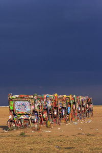 Bicycles on sandy beach against blue sky