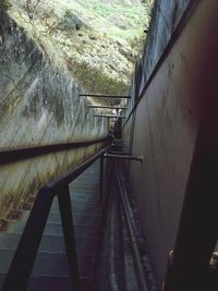 Man standing on railing by water