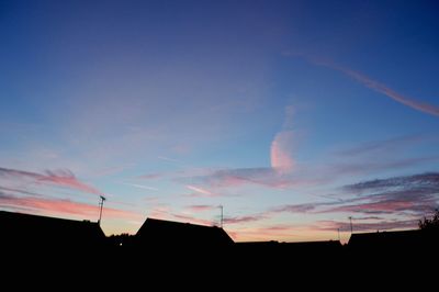 Low angle view of building against sky at sunset