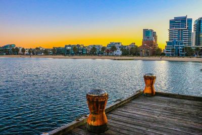 View of city at waterfront during sunset