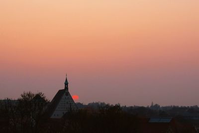 Buildings against sky at sunset