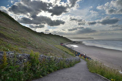 Road by sea against sky