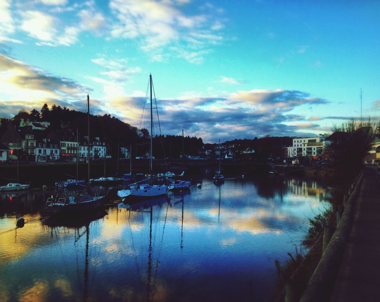 reflection, sky, water, cloud - sky, sunset, building exterior, moored, cloud, lake, waterfront, harbor, built structure, architecture, nautical vessel, transportation, mode of transport, cloudy, river, city, nature