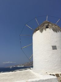 Traditional windmill against clear blue sky