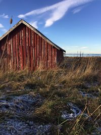 Abandoned barn on landscape against sky