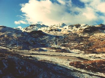 Scenic view of snow covered mountains against sky