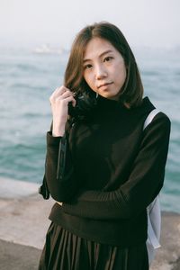 Portrait of woman standing on beach