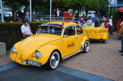 Yellow toy car on street in city