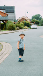 Portrait of young woman walking on road