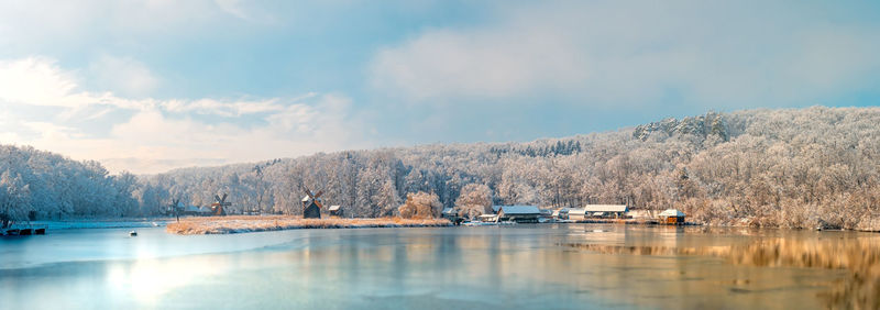 Winter panorama with windmills on a foggy winter day