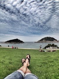 Low section of people relaxing on beach